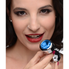 Woman holding Booty Sparks Blue Gem Weighted Anal Plug with silver and blue gem