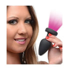 Black handheld device emitting pink mist, compatible with Bootysparks silicone vibrating LED plug