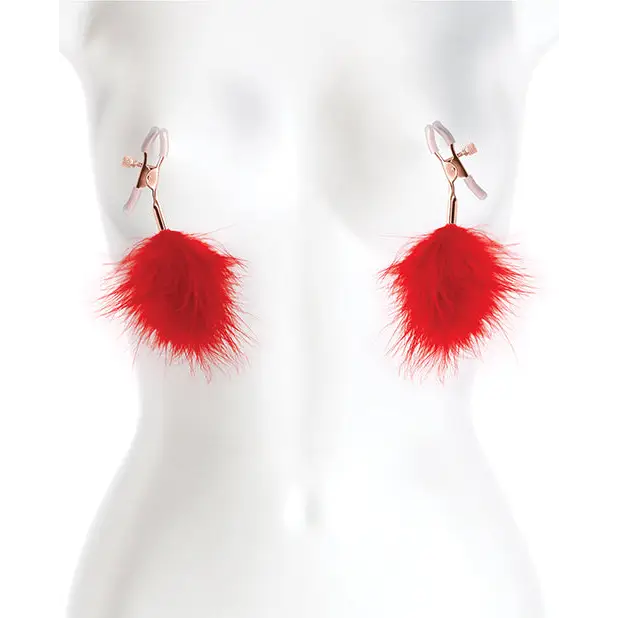 Close-up of Bound Nipple Clamps on mannequin torso with red feathers