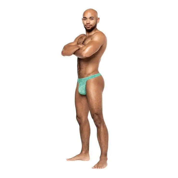 Muscular bald man wearing Caribbean Crush Thong swimsuit, standing with arms crossed