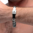 Hairy wrist wearing a chained locking bracelet with chain link design and square clasp