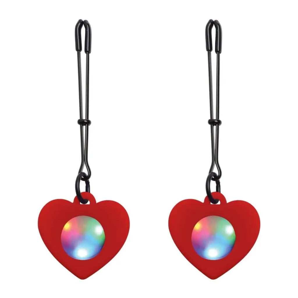 Heart-shaped red LED pendants on tweezer nipple clamps for a charming intimate touch