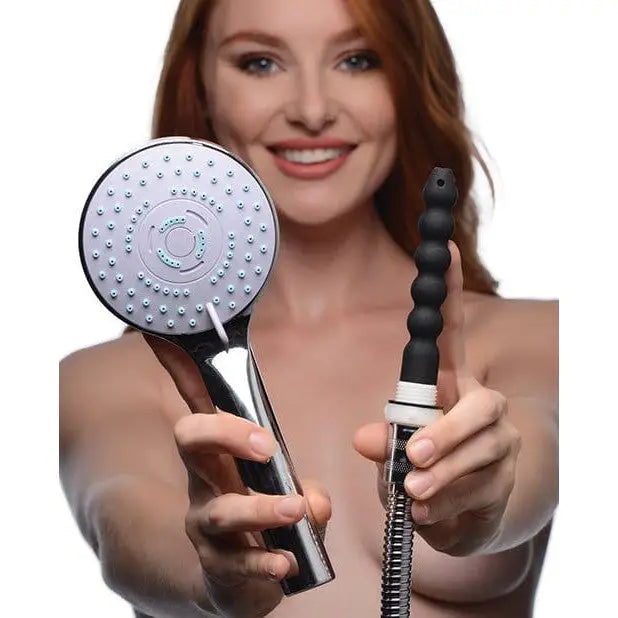 Arafed woman holding CleanStream Discreet Silicone Shower Enema Set shower head