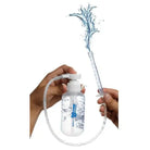 Hand holding CleanStream Pump Action Enema Bottle with blue water splash