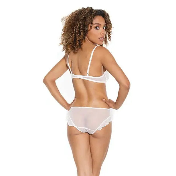 Woman with curly hair in stretch mesh ruffled crotchless teddy, viewed from behind