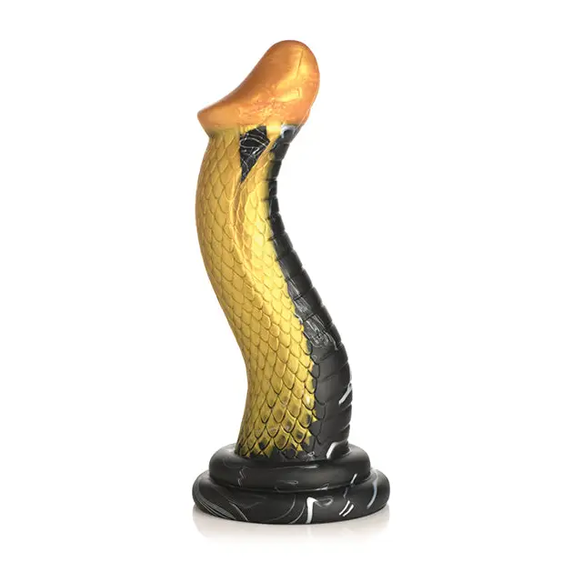 Close-up of Creature Cocks Golden Mamba Silicone Dildo snake statue on white surface