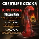 Close up of Creature Cocks King Cobra Silicone Dildo, mimicking a snake on a rock