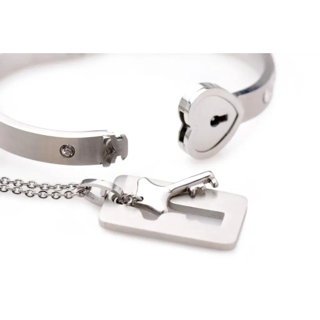 Cuffed locking bracelet paired with a key necklace in durable tungsten steel