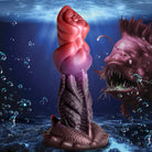 Deep Diver Silicone Dildo shaped like a red-topped, scaly sea creature emerging from water