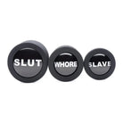 Three black buttons labeled shut, where slave, and slave from Dirty Words Anal Plug Set