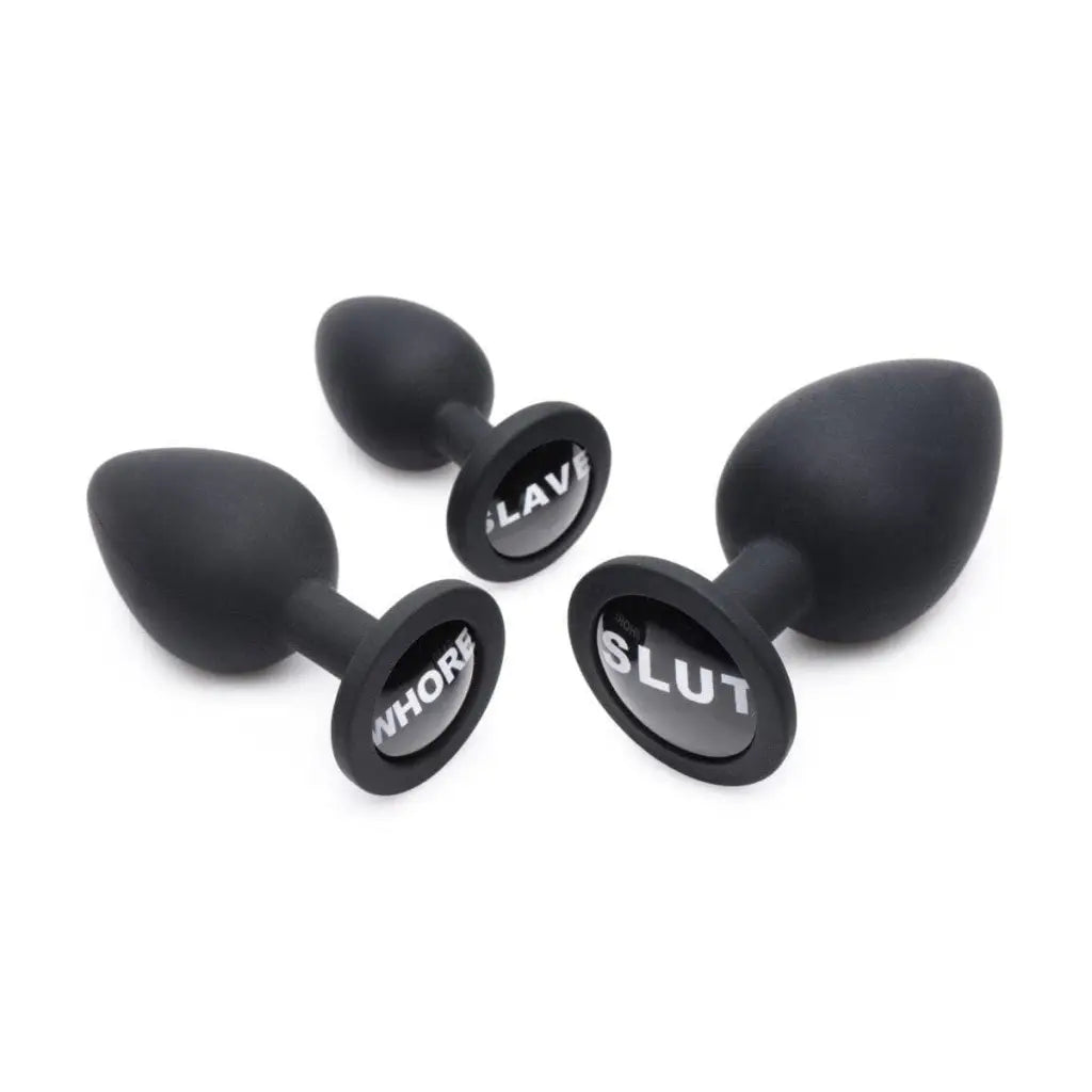 Black ear plugs with ’u’ from the Dirty Words Anal Plug Set