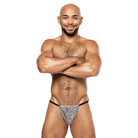 Muscular bald man with a beard in Disco Desire Posing Strap swimsuit, showcasing style and fit