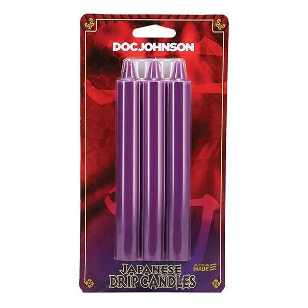 Three purple cylindrical Japanese drip candles in retail packaging by Doc Johnson