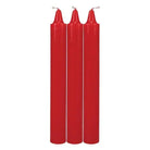 Three tall, slender red candles with white wicks from Doc Johnson Japanese Drip Candles