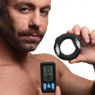 Man using E-Stim Pro Silicone Vibrating Cock Ring with a digital glucose device