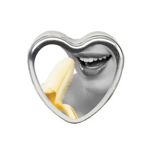 Earthly Body Massage Candle Edible Banana 4oz with banana and smiling lips in a heart tin