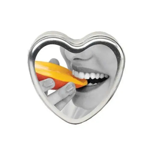 Heart shaped cookie pierced by a pencil with Earthly Body Massage Candle Edible Mango 4oz