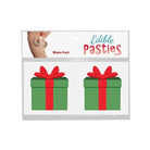 Package of Edible Body Pasties shaped like green gift boxes with red bows for Christmas