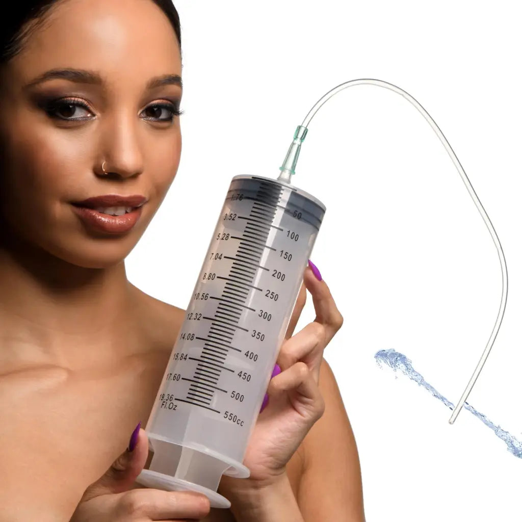 Woman with purple nails holding Enema Syringe with silicone tube and tapered tip