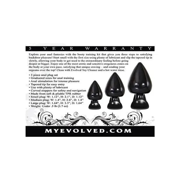 Black velvet shoe beside Evolved Anal Delights TPR Rubber Butt Plug Kit