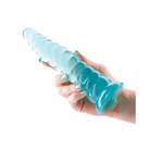 A hand holding a blue plastic bottle next to the Fantasia Nymph Jelly Dildo Teal, highlighting dimensions in inches