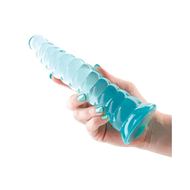 A hand holding a blue plastic bottle next to the Fantasia Nymph Jelly Dildo Teal, highlighting dimensions in inches