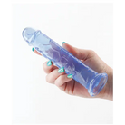 Hand holding a plastic bottle with blue liquid, part of Fantasia Upper 6.5 in. Jelly Dildo Blue