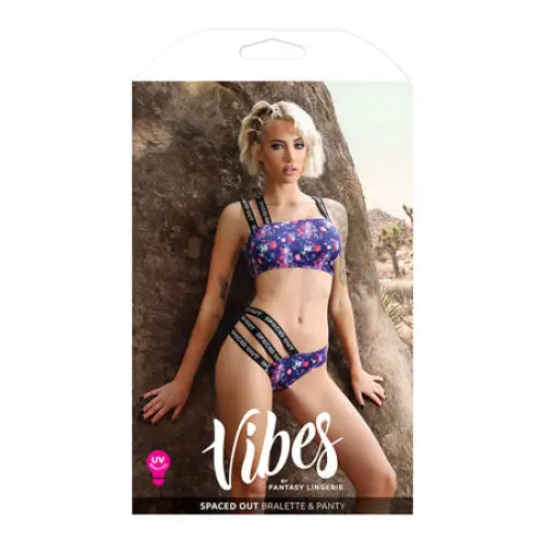 Model in UV Reactive Print Fantasy Lingerie Vibes Bralette & Multi Strap Panty, Indigo L/XL