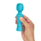 Hand holding Femme Funn Ultra Wand Mini, showcasing the small blue figure in detail