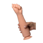 A hand holding the Fisto Clenched Fist Dildo, showcasing its realistic clenched fist design