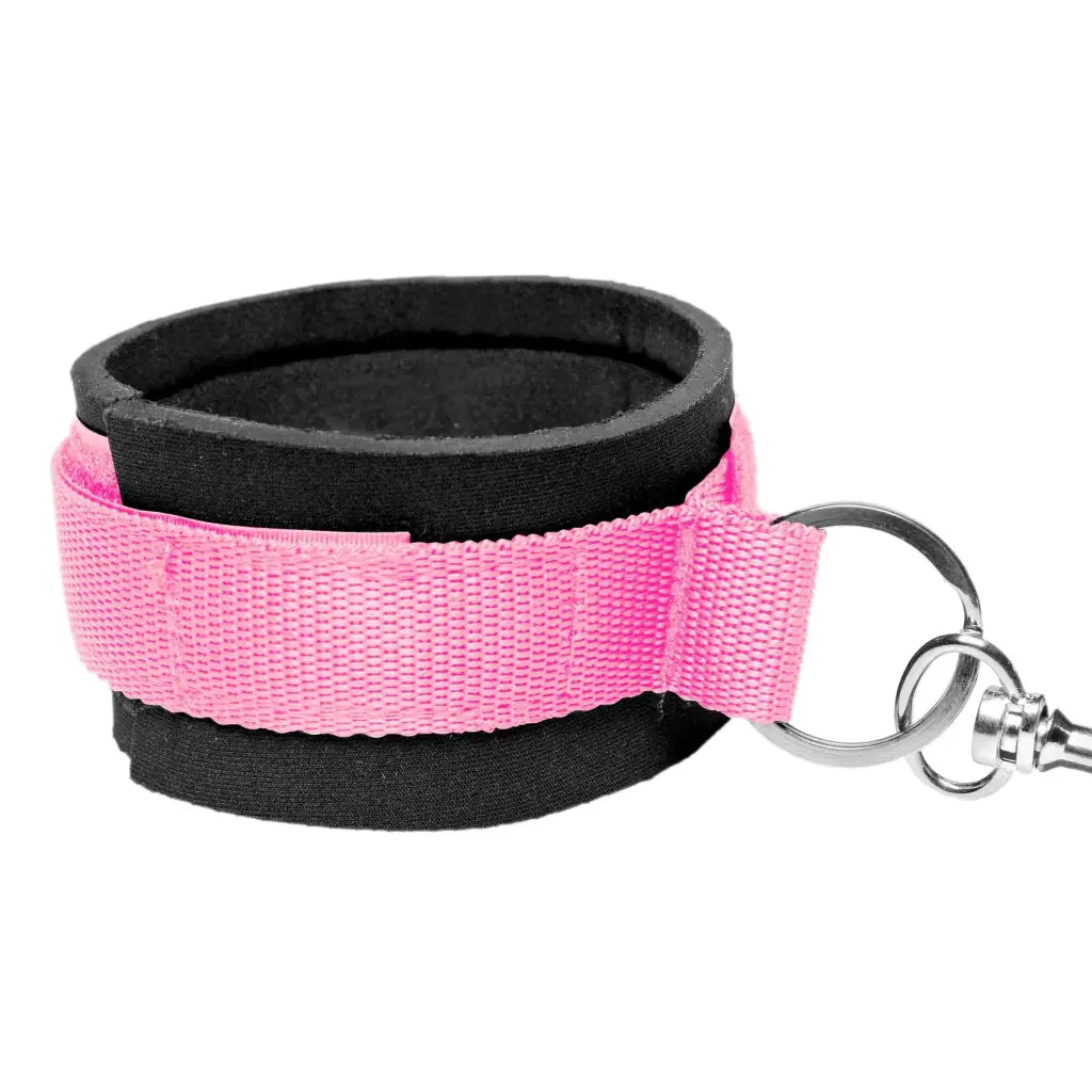 A pink wrist strap with metal ring from the Frisky Pink Bedroom Restraint Kit