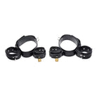 Pair of black leather cuffs with brass hardware from the Frog-tie Restraint Set