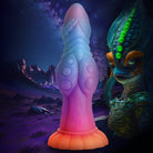 Suction cup base phallic alien silicone dildo with glow-in-the-dark texture and colorful design