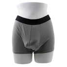 Gray boxer briefs with black waistband showcasing Gender X Packer Silicone 4in Medium