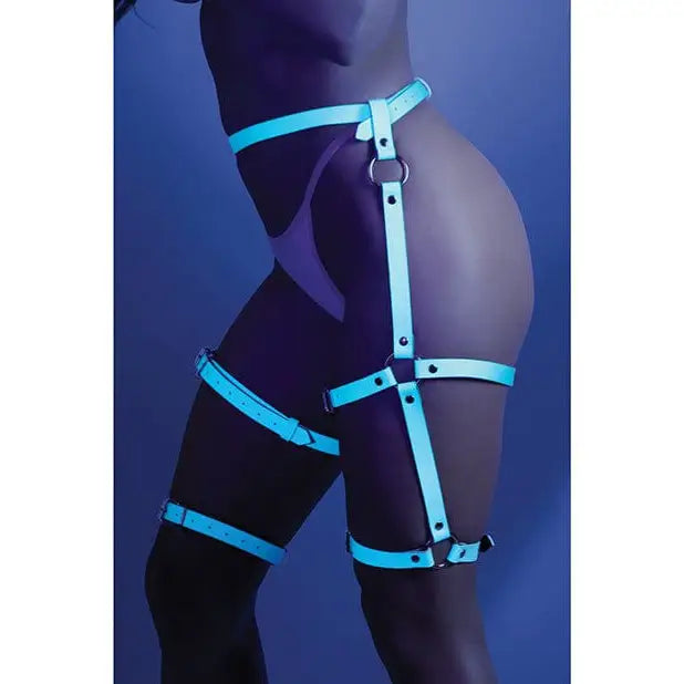 Glow ’Buckle Up’ dark leg harness by Fantasy Lingerie against a dark background