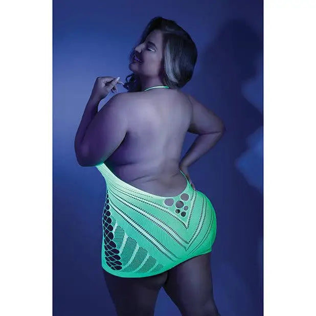 Curvaceous woman in bright green mini skirt, wearing Fantasy Lingerie net halter dress