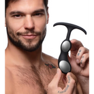 Tattooed hand holding Heavy Hitters Premium Silicone Weighted Prostate Plug in black and silver