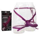 Close-up of Her Royal Harness Me2 Rumbler Strap On Kit by CalExotics with bottle and glass