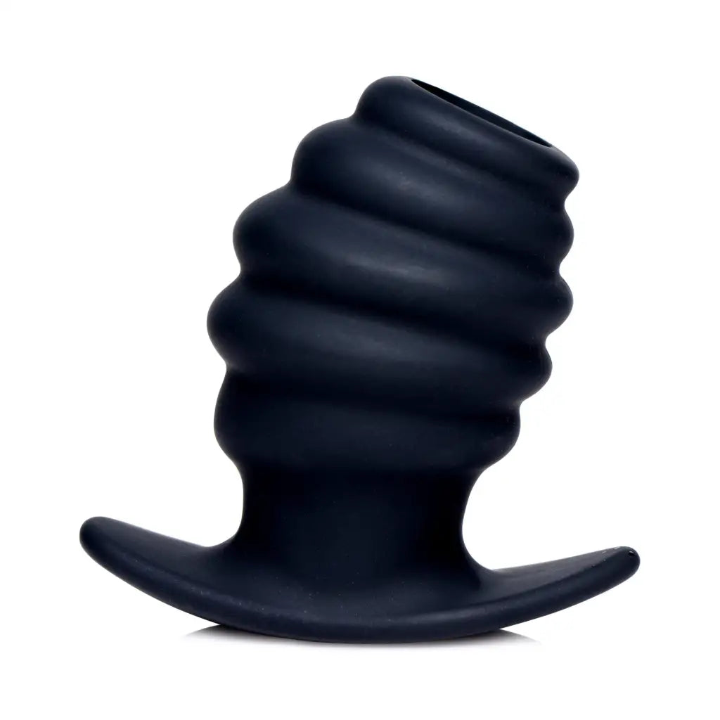 The black silicone vibrating device in Hive Ass Tunnel Silicone Ribbed Hollow Anal Plug