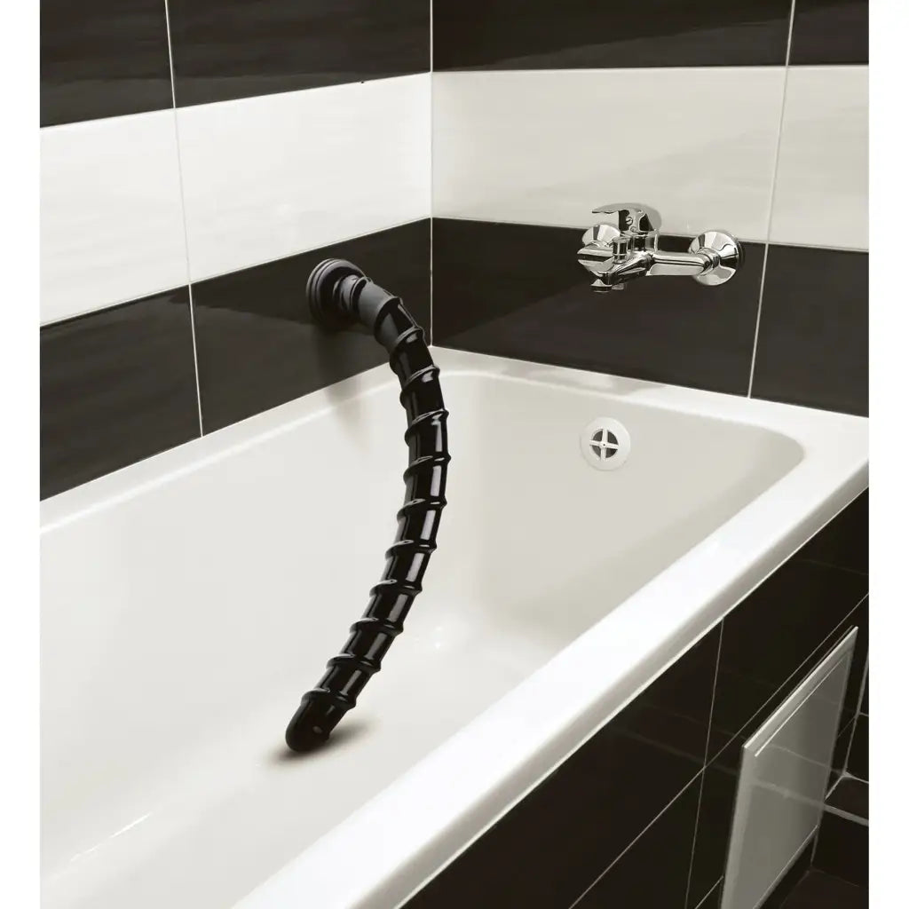 Segmented black flexible tube emerging from a bathroom sink - Hosed 18 Inch Swirl Anal Snake