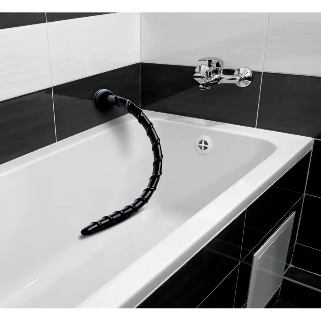 Black segmented swirl anal snake faucet emerging from a white sink - Hosed 18 Inches Swirl Anal