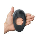 Hand holding Hot Octopuss ATOM PLUS Dual Motor Rechargeable Cock Ring with a hole