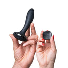 Woman holding Hot Octopuss PleX Rechargeable Dual-Motor Butt Plug and Remote