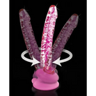 Hand blown glass massager with suction cup and rotating pink appendages on pink base