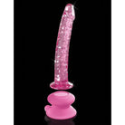 Pink translucent hand blown glass massager with textured surface and suction cup base