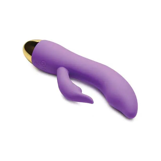 Purple Inmi 10x focus silicone vibrator with curved shape and gold-colored tip