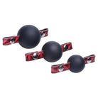 Set of three black interchangeable silicone ball gags with red leather straps