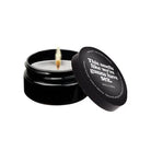 Mini massage candle in black jar with humorous label, perfect for intimate moments