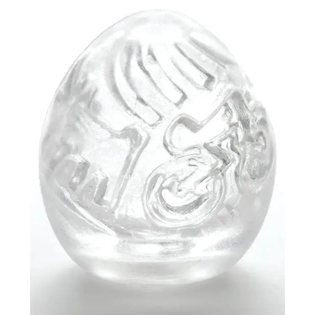 Clear egg-shaped Keith Haring Tenga Egg with intricate swirling patterns inside