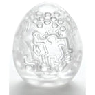 Clear egg-shaped Keith Haring Tenga object with abstract etched figures and circles